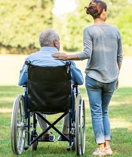 elderly patient in wheelchair with carer