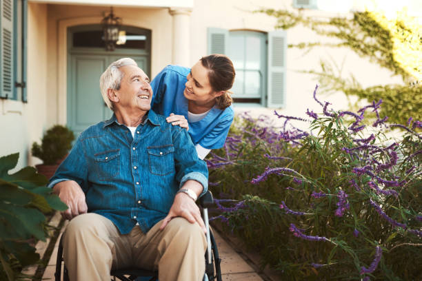 carer talking to male patient on wheelchair