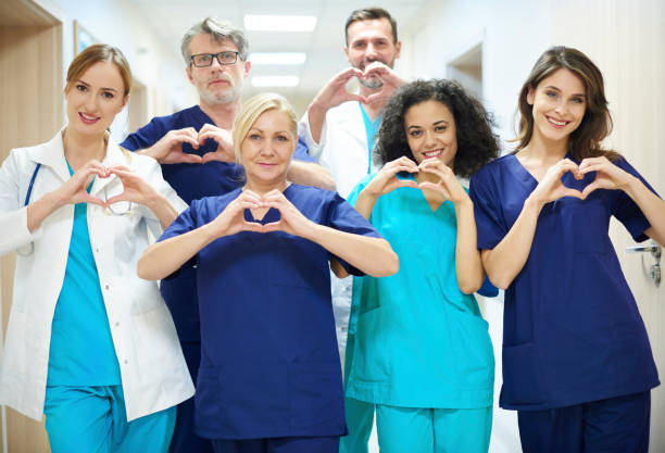 clinical staff doing heart shape with their hands